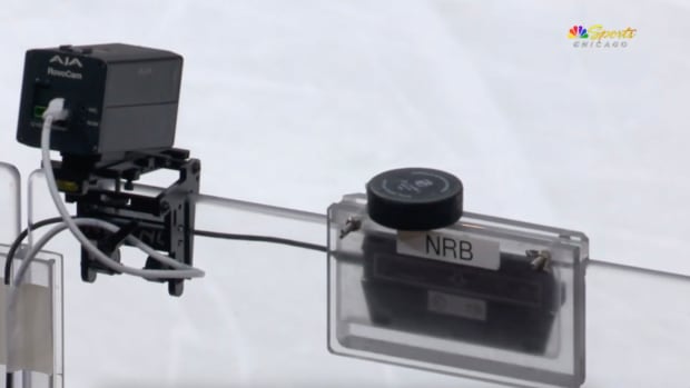 A hockey puck resting on the top of the glass